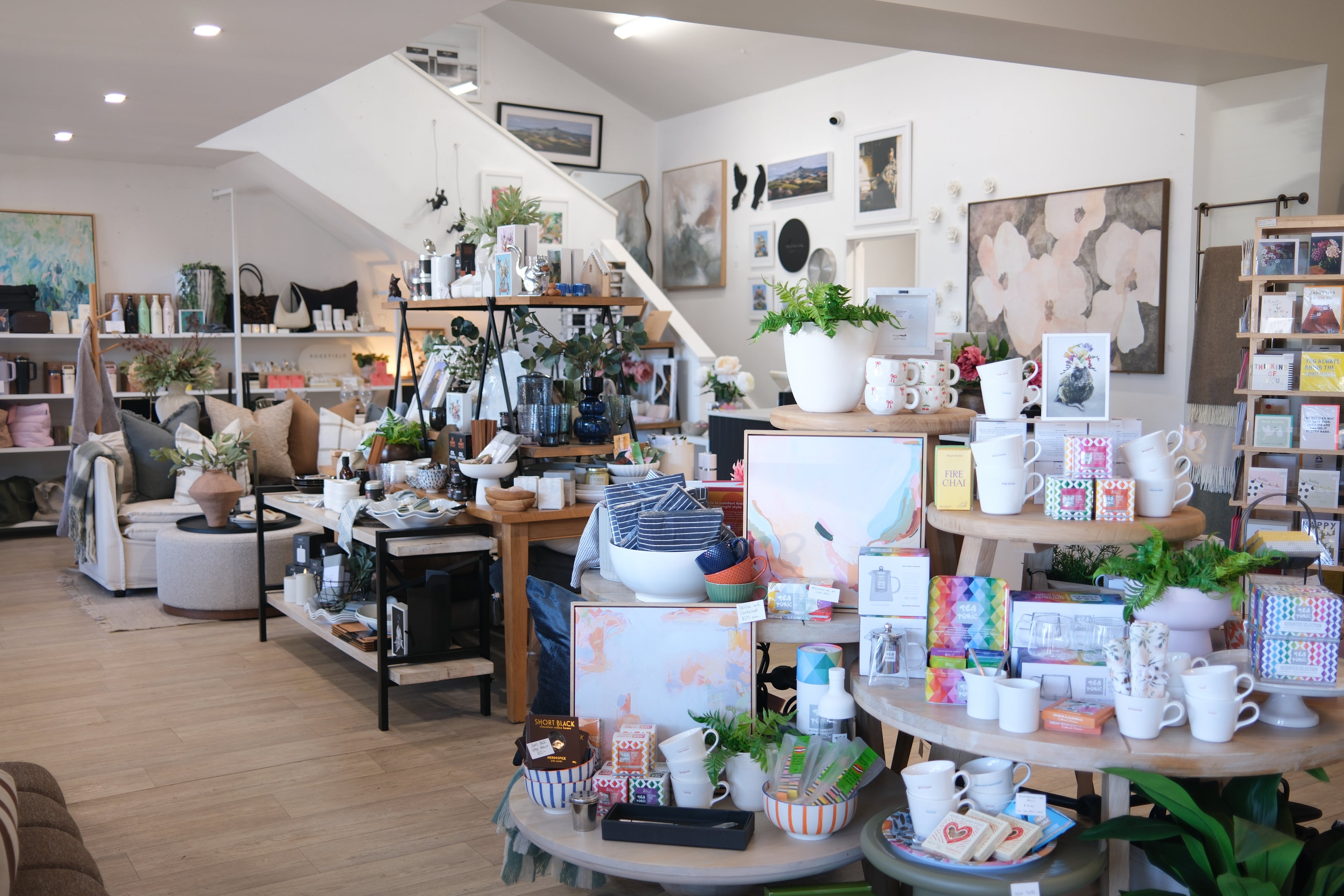 Store interior with various products on display, including furniture and decor items.